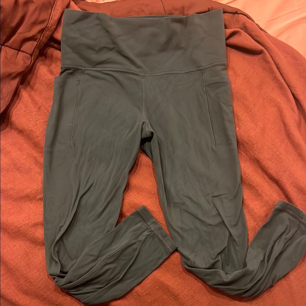 Athleta Dark Green Salutation Stash Pocket Leggings